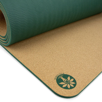Two yoga mats, one green and one brown with a visible brand logo, on a white background.
